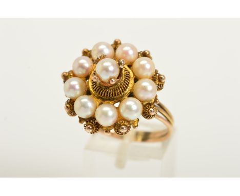 A CULTURED PEARL RING, designed as a central spherical cultured pearl in a decorative four claw setting within a cannetille s