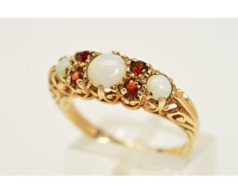 A 9CT GOLD OPAL AND GARNET RING, designed as three graduated circular opal cabochons interspaced by four circular garnets to 