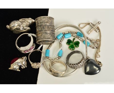 A SELECTION OF JEWELLERY ETC, to include three rings, a torque bangle, a cross pendant, a small rabbit pin cushion and a smal