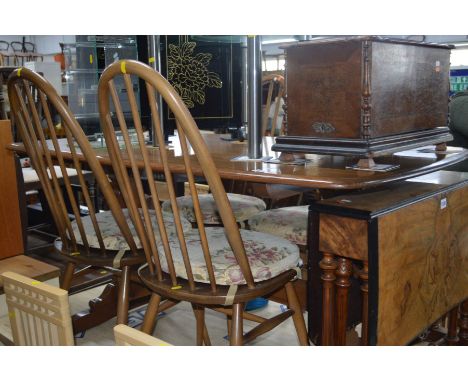 AN ERCOL GOLDEN DAWN REFECTORY TABLE, width 152cm x depth 84cm x height 72cm and four spindle hoop back chairs with removable