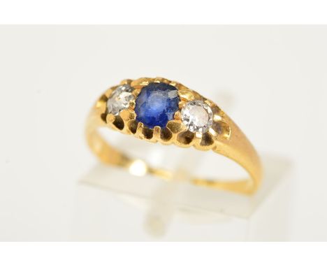 AN 18CT GOLD LATE VICTORIAN SAPPHIRE AND DIAMOND RING, designed with a central oval cut sapphire flanked by an old cut diamon