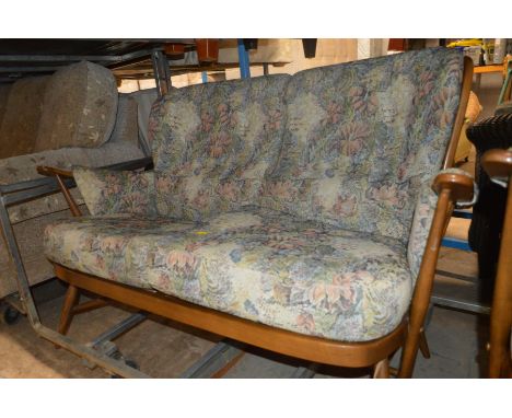 AN ERCOL GOLDEN DAWN FOUR PIECE LOUNGE SUITE comprising of two arm chairs, a two seater settee and a pouffe (4)