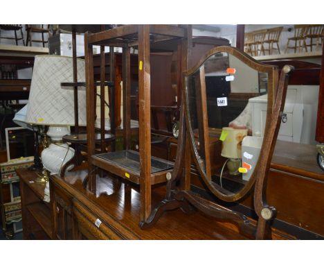 AN EDWARDIAN MAHOGANY SHIELD TOILET MIRROR together with a mahogany folding cake stand, oak umbrella stand, ceramic table lam