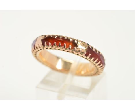 A CARNELIAN RING, an eternity style ring claw set with four faceted pieces of carnelian, ring size O1/2, approximate weight 3