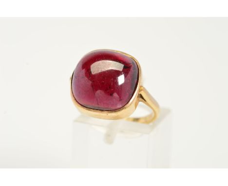 A GARNET RING, designed as a cushion-shape garnet within a collet setting to the plain band, stamped 9ct, ring size L, approx