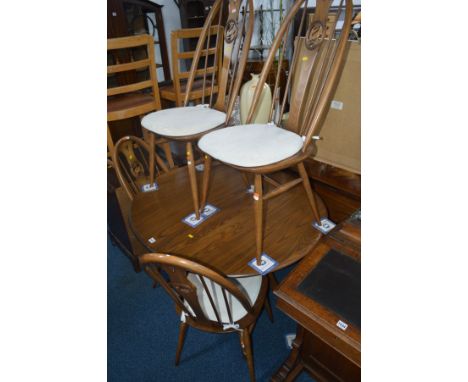 AN ERCOL GOLDEN DAWN EXTENDING PEDESTAL DINING TABLE, one additional leaf, extended width 148cm x width 110cm x depth 100cm x