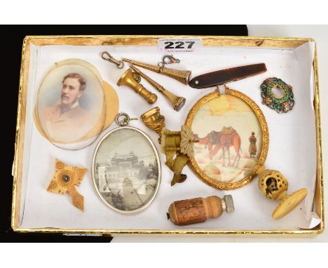 A SELECTION OF ITEMS, to include mother of pearl tape measure, two decorative watch keys, two seals, a portrait panel from a 