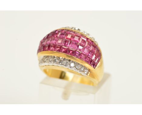 A RUBY AND DIAMOND DRESS RING, the central domed panel comprising four rows of square cut rubies, flanked by a row of brillia