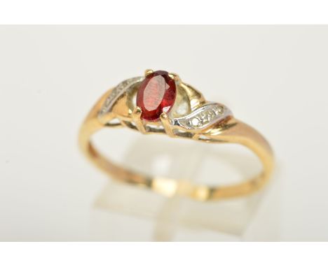 A 9CT GOLD GARNET AND DIAMOND RING, designed with a central oval cut garnet flanked with three single cut diamonds either sid