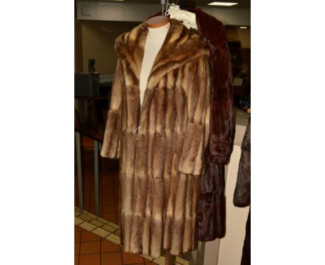 TWO FUR COATS, to include a musquash fur coat with wide lapel collar, four hook fastenings and inner ribbon tie, together wit