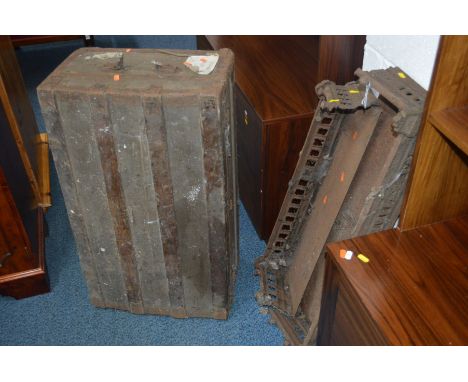 TWO EDWARDIAN CAST IRON FIRE FENDERS, one 78cm wide the other 88cm wide and a travelling trunk (3)