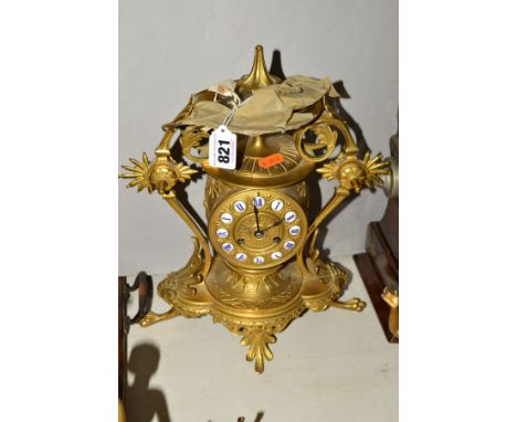 A LATE 19TH CENTURY GILT METAL MANTEL CLOCK, cast with Etruscan style decoration, gilt dial with blue and white enamel Roman 