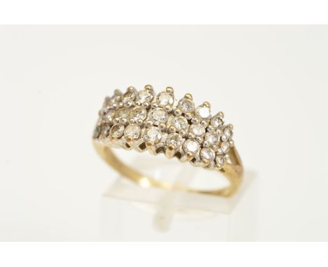 A 9CT GOLD DIAMOND DRESS RING, designed as three graduated rows of claw set brilliant cut diamonds, stamped total diamond wei
