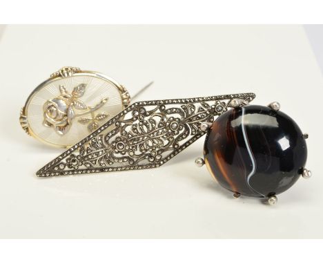 THREE BROOCHES, the first a late Victorian oval banded agate brooch within a silver claw and bead setting, the second a Norwe