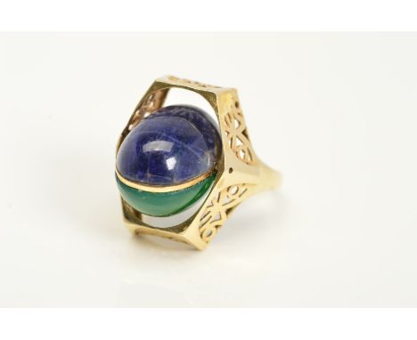 A GEM SET SWIVEL RING, designed as a central oval swivel panel set to one side with a sodalite cabochon and to the other a dy