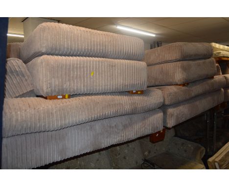 AN OATMEAL FOUR PIECE LOUNGE SUITE comprising of a two seater settee (splits in two), armchair and two pouffes (5)