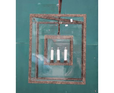 A wrought iron and glazed hanging lantern, 20th century, of square section, with four glass panes enclosing a subsidiary four