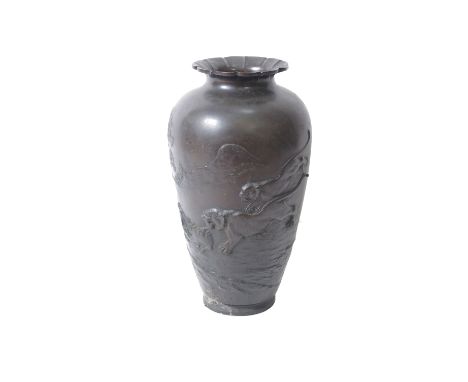 A Japanese bronze vase with a flared top and decorated with embossed hunting scene 55cm high