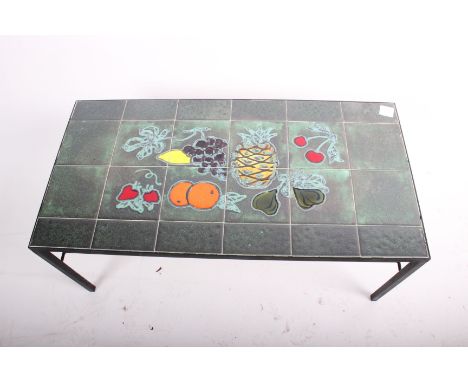 A tile top coffee table, the surface decorated with fruit 