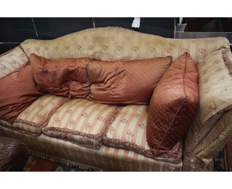 An early 20th century arched back sofa and armchair