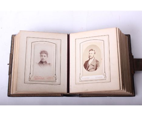 A Victorian leather covered embossed photograph album containing 34 Victorian portrait (35 x 2inch) mainly by Bristol studios