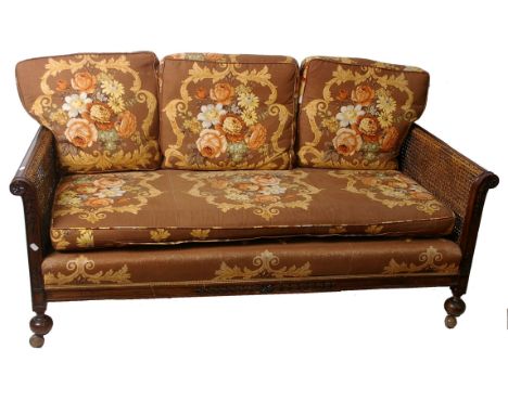 An early 20th century mahogany framed double caned three piece bergere suite, sofa 160cm length 