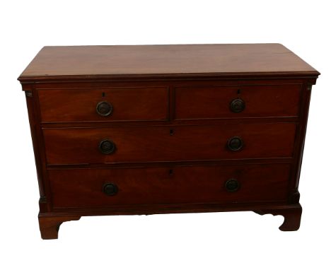 A George III mahogany chest with two short and two long drawers, flanked by brass capped quarter column supports, on bracket 