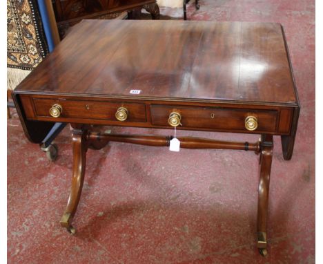 A Regency mahogany and ebony strung sofa table, circa 1815, with two short drawers to one long end, 71cm high, 143cm wide ext