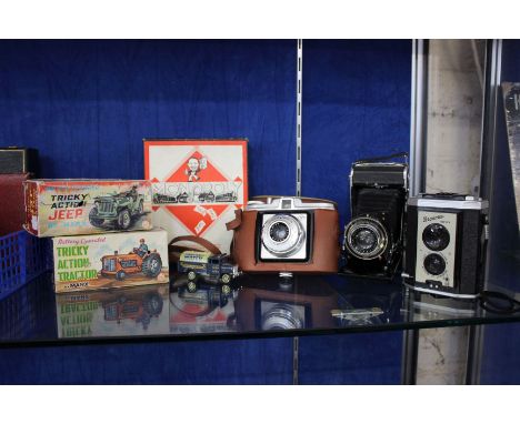 Mixed lot: a Zeiss Ikon Klio folding camera, a Brownie Reflex camera (boxed), a 'black box' Monopoly money and pieces box, a 