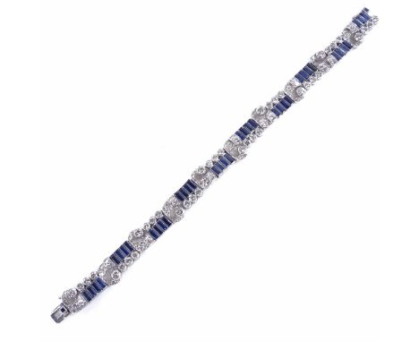 An Art Deco sapphire and diamond bracelet, circa 1930s, geometric and scroll form, set with rectangular calibre-cut sapphires