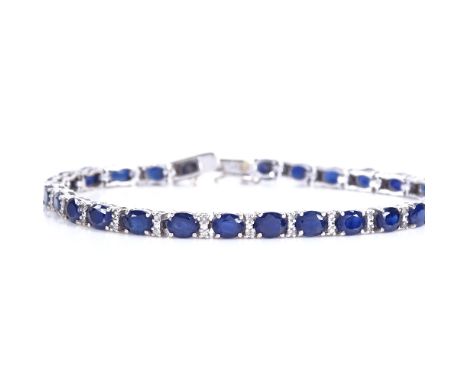 A modern 18ct white gold sapphire and diamond tennis line bracelet, total diamond content approx 0.35ct, bracelet length 18cm