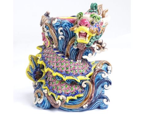 A Chinese glazed ceramic dragon design candle stand, impressed marks under base, height 14cmThe dragon has two tiny chips on 