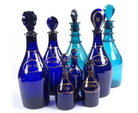 A group of 8 various Bristol blue and green glass decanters and condiment bottles, with painted gilded labels and original st