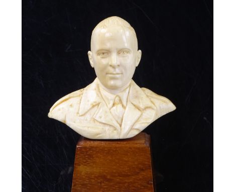 A Second War Period carved ivory bust of a British Army Officer, on wood plinth base, label on reverse reads "Made by POW in 