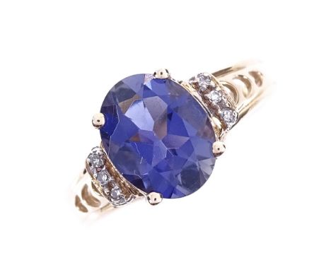 A modern 9ct gold iolite and diamond dress ring, with pierced heart shape shoulders, iolite length 10mm, size O, 3.1gVery goo