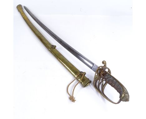 A Victorian Navy Officer's dress sword with brass hilt, etched blade and brass scabbardBlade in good condition, signs of ligh