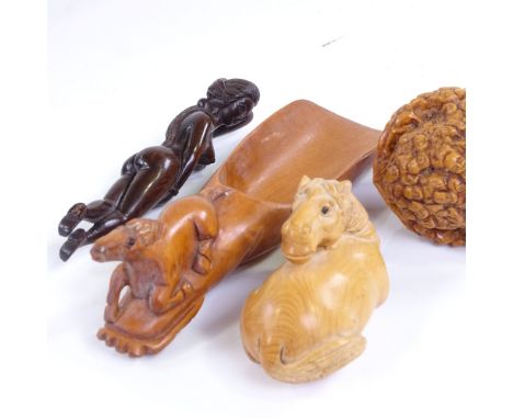 A group of Japanese wood carvings and netsuke, including a doctor's figure, length 9.5cm, and a walnut with carved faces (4) 
