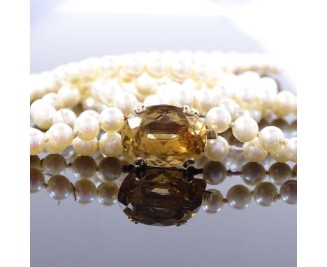 A Vintage double-strand cultured pearl necklace, pearls measuring 5.6mm on unmarked gold citrine clasp, necklace length 66cm,