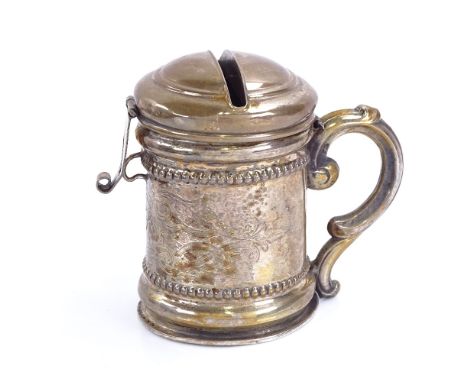 A German unmarked white metal tankard moneybox, with hinged lockable lid and bright-cut engraved decoration, unmarked, height