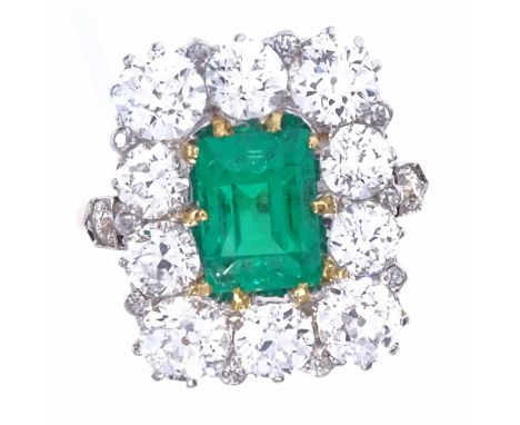 A rectangular emerald and diamond cluster ring, early 20th century, central emerald step-cut emerald within a surround of 10 