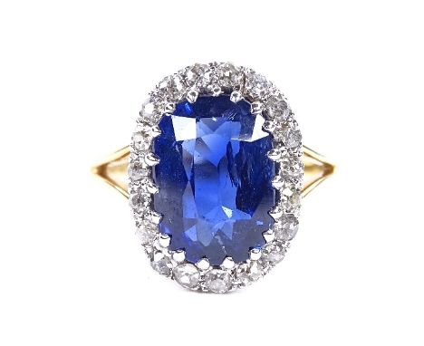 An oval sapphire and diamond cluster ring, circa 1915, central oval mixed-cut sapphire approx 5.66ct, surrounded by old-cut d