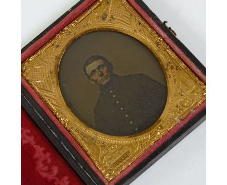 A 19th century American Civil War tin-type photograph, portrait of a soldier in an embossed Stars and Stripes flag frame with