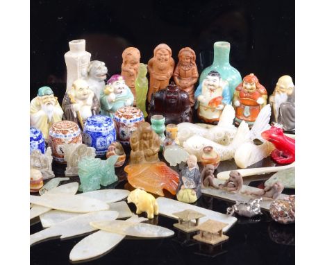 A collection of miniature Oriental porcelain figure perfume bottles, a carved amber netsuke in the form of a scribe, a Chines