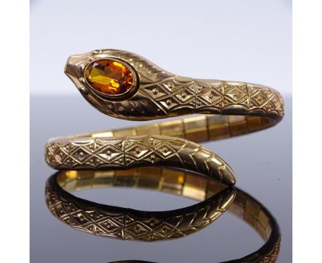 A rolled gold and citrine snake spring bangle bracelet, internal diameter 54mm, head width 15.5mm, 21gGood overall condition,