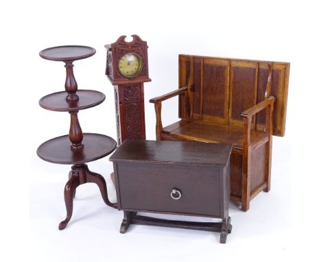 A group of doll's furniture, including oak monk's settle, width 27cm, a miniature longcase clock, a mahogany 3-tier dumb wait