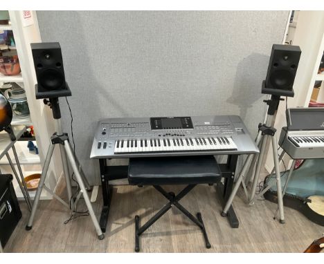 A Yamaha Tyros 5 digital workstation / keyboard with a pair of Yamaha MSP5 monitor speakers and flight cases with accessories
