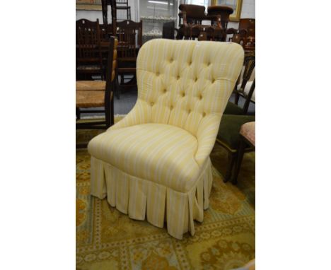 A modern yellow striped upholstered button back bedroom chair.