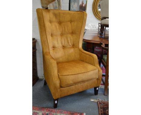 A good Georgian style gold velour upholstered button back wing armchair.