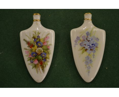 Two Royal Worcester blush ivory and floral decorated scent bottles.