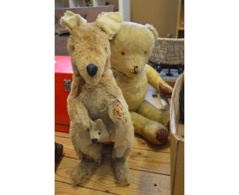 A old stuffed toy of a model a kangaroo and joey and a teddy bear.